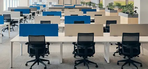 Modern open-plan office space featuring clean workstations, ergonomic chairs, and sanitized carpets provided by professional office cleaning services in Baton Rouge, LA.