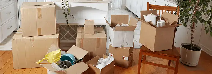 Packed moving boxes and household items in a kitchen before move-out or move-in cleaning, Baton Rouge, LA.